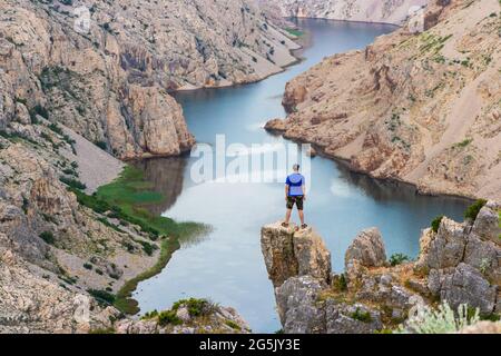 Man is standing on the cliff above the canyon of the Zrmanja River, Croatia Stock Photo