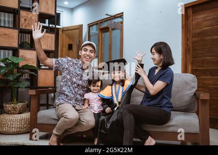 Happy asian family graduate at home. elementary school student at home celebrating Stock Photo