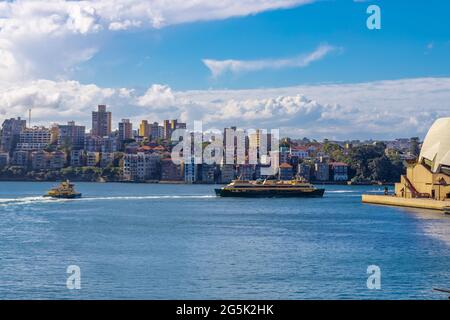 Sydney Harbour Australia on a sunny clear blue sky day with the turquoise colours of the bay and high rise offices of the City in the background Stock Photo
