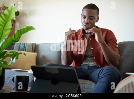 Young African man on a video call while working at home Stock Photo