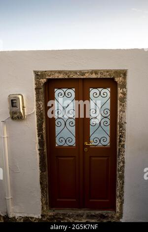 A open-air Cycladic style doorway leads to private accommodations on the island of Santorini in Greece. Stock Photo