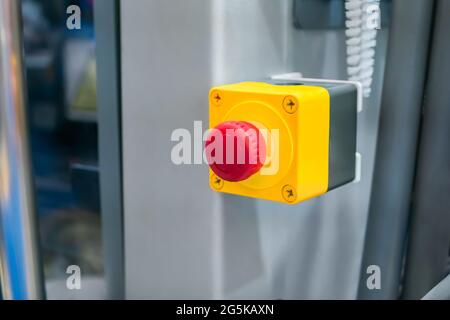Machine control panel with red switch button - emergency stop at factory Stock Photo