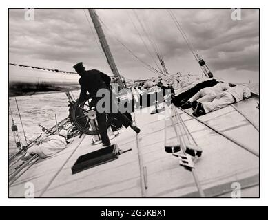 AMERICAS CUP WINNER 1903 Crew lying on high side to balance the yacht Reliance, winner of 1903 America's Cup Photograph shows gaff cutter designed by Nathanael Greene Herreshoff and built by Herreshoff Manufacturing Company, Bristol, Rhode Island, for the 1903 America's Cup. By James Burton photographer -  Reliance (Yacht)--1900-1910 America's Cup--(12th :--1903 :--New York, N.Y.)--Equipment & supplies Sailboats--American--1900-1910 -  Yachts--American--1900-1910 Sailing--1900-1910 Stock Photo