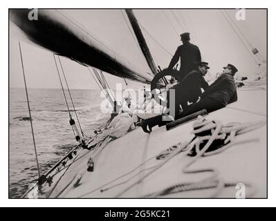 AMERICAS CUP WINNER 1903  crew lying on tilting deck of the yacht Reliance, winner of 1903 America's Cup Photograph shows gaff cutter designed by Nathanael Greene Herreshoff and built by Herreshoff Manufacturing Company, Bristol, Rhode Island, for the 1903 America's Cup. Burton, James, photographer [1903] -  Reliance (Yacht)--1900-1910 -  America's Cup--(12th :--1903 :--New York, N.Y.)--Equipment & supplies -  Sailboats--American--1900-1910-  Yachts--American--1900-1910  Sailing--1900-1910 Stock Photo