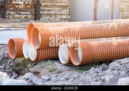 Pipes plastic corrugation large diameter red and orange for construction Stock Photo