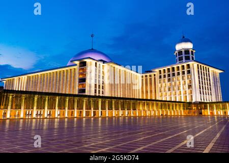 Jakarta, Indonesia - CIRCA June 2021: Exterior of Istiqlal Mosque, Jakarta, Indonesia; at sunset or blue hour Stock Photo