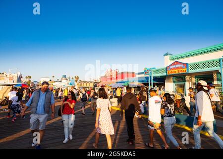 Tourists on the pier at sunset, Santa Monica, California, United States of America. Stock Photo