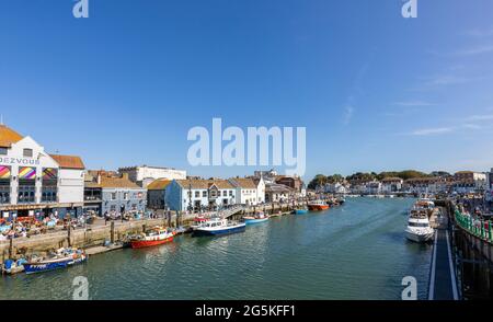 Harbourside pubs and restaurants in Weymouth, a seaside town and popular holiday resort on the estuary of the River Wey in Dorset, south coast England Stock Photo