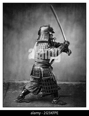 SAMURAI WARRIOR 1860's Traditional Japanese Samurai in armour brandishing Sword by Felice Beato Samurai were the hereditary military nobility and officer caste of medieval and early-modern Japan from the late 12th century to their abolition in 1876. Stock Photo