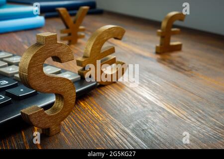 Global economic and currency exchange. Symbols of world currencies on the table. Stock Photo