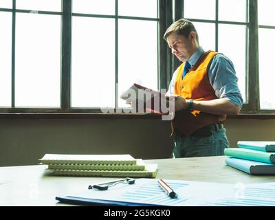 Businessman or manager reads financial company report near window. Stock Photo