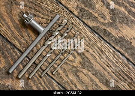 Key for chuck and concrete drills bit on wooden background Stock Photo