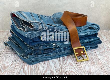 Casual clothing on wooden board, jeans and accessories close-up Stock Photo