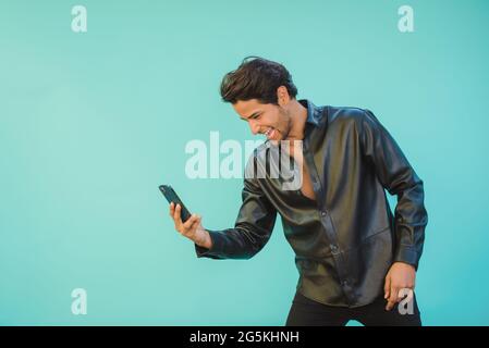Content man taking selfie on smartphone while leaning forward Stock Photo