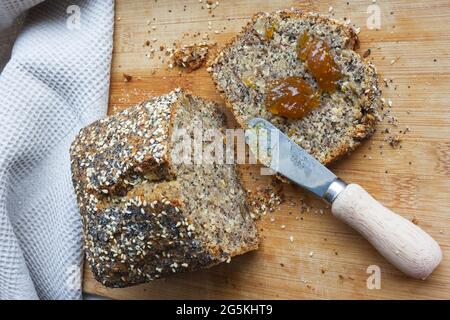 Whole grain banana bread, multigrain organic homemade bread on wooden background Stock Photo