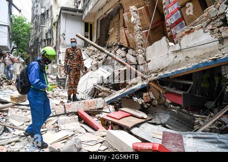 Dhaka, Bangladesh. 28th June, 2021. An official from the Criminal Investigation Department (CID) inspects the spot of a suspected gas explosion in Dhaka. At least seven people were killed and 50 were injured so far as three-storied building in Moghbazar area in Bangladesh's capital Dhaka collapsed partially in an suspected gas explosion. A day after the incident. Credit: SOPA Images Limited/Alamy Live News Stock Photo
