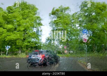 Rainy weather, view through rainy windshield while driving, Germany, Europe Stock Photo