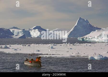 Fishing boat in front of icebergs, Disko Bay, Ilulissat, Greenland, Denmark, North America Stock Photo