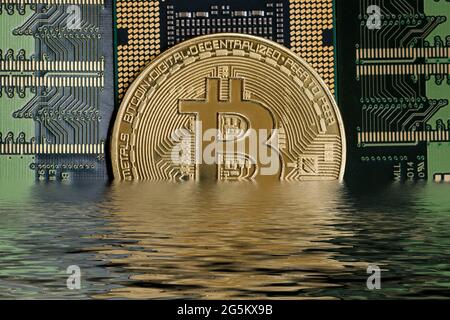 Cryptocurrency Bitcoin half under water Stock Photo