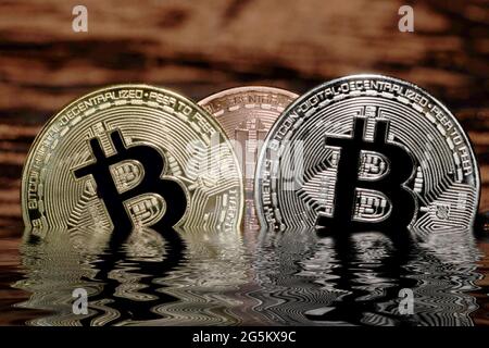 Cryptocurrency Bitcoin half under water Stock Photo