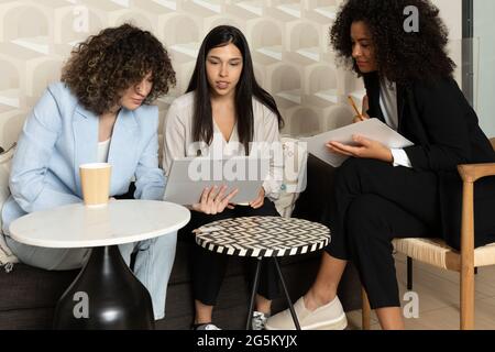 Happy business women sitting in a couch in the office and working together. office concept. Stock Photo