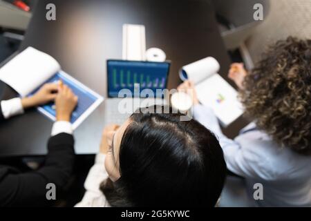 Unrecognized female office workers using digital tablet during a meeting. Stock Photo