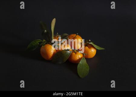 Crop of group of tangerines on the dark background Stock Photo
