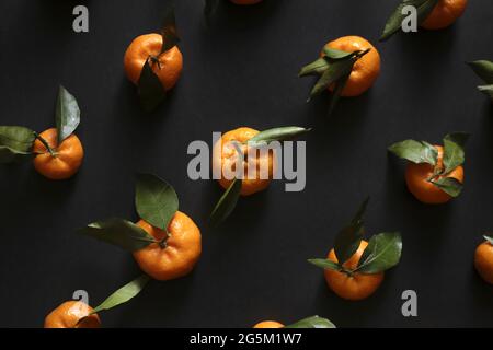 Top view of pattern of tangerines on the dark background Stock Photo