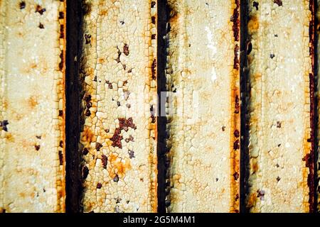 Macro closeup of peeling rusty rust metal white green door abstract background Stock Photo