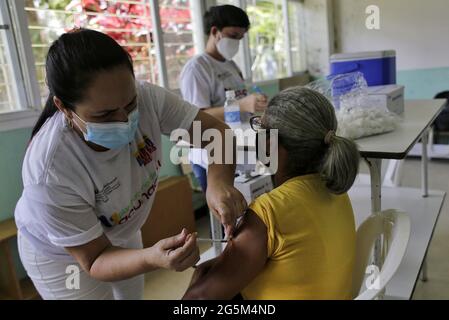 Caracas, Venezuela. 28th June, 2021. A health worker administers a dose of the Corona vaccine Abdala to an elderly woman. This first shipment of vaccine from Cuba is expected to provide an initial dose to 10,000 people in Venezuela, according to Cuban authorities. Credit: Jesus Vargas/dpa/Alamy Live News Stock Photo