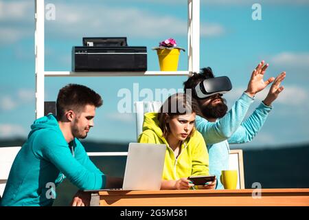 Business people working with virtual reality glasses during a business meeting. Developers in virtual reality simulator in creative office Stock Photo