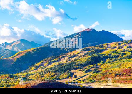 View of Aspen city, Colorado USA and buttermilk ski slope hill in rocky mountains peak with colorful autumn foliage aspen trees in Roaring fork valley Stock Photo