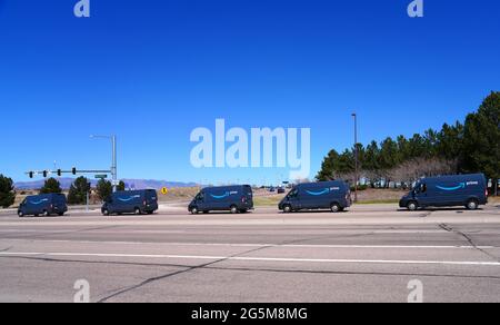 COLORADO SPRINGS, CO- 10 APR 2021- View of a line of blue Amazon Prime delivery vans on the road in Colorado, United States. Stock Photo