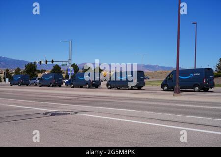 COLORADO SPRINGS, CO- 10 APR 2021- View of a line of blue Amazon Prime delivery vans on the road in Colorado, United States. Stock Photo