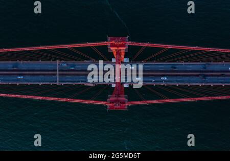 Aerial birds eye overhead top down view of cars driving on multilane road suspension bridge over Tagus river. Lisbon, Portugal. Stock Photo