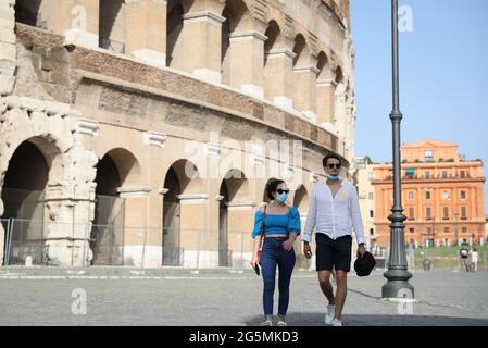 Rome, Italy. 28th June, 2021. Tourists visit the Colosseum in Rome, Italy, on June 28, 2021. All regions of Italy on Monday become the so-called 'white zone,' with the lowest level of anti-coronavirus rules in the country's four-tiered system. People are no longer required to wear face masks outdoors except for large gatherings. Credit: Cheng Tingting/Xinhua/Alamy Live News Stock Photo