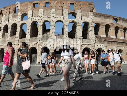 Rome, Italy. 28th June, 2021. Tourists visit the Colosseum in Rome, Italy, on June 28, 2021. All regions of Italy on Monday become the so-called 'white zone,' with the lowest level of anti-coronavirus rules in the country's four-tiered system. People are no longer required to wear face masks outdoors except for large gatherings. Credit: Cheng Tingting/Xinhua/Alamy Live News Stock Photo