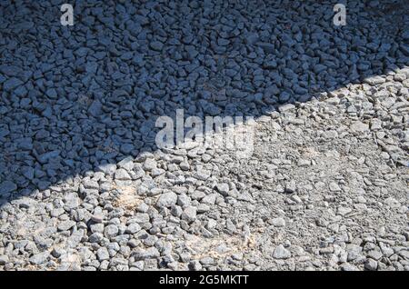 Natural Gray Granite Chippings, Macadam, Rubble or Crushed Stones Background Top View. Crushed Rock Texture with Place for Text Stock Photo