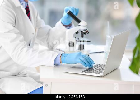 Male scientist using laptop in laboratory Stock Photo