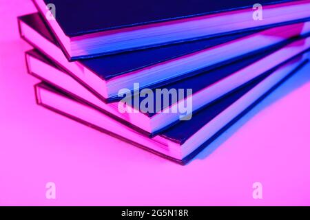 Stack of books on dark color background, closeup Stock Photo