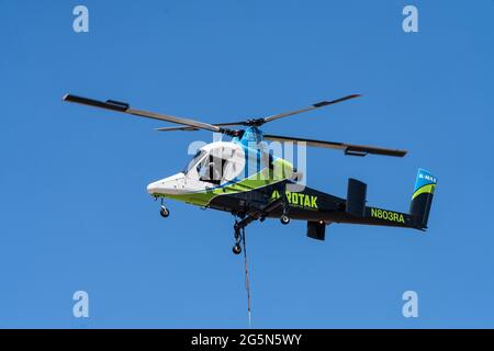 A Kaman K-Max K-1200 heavy-lift firefighting helicopter coming in to land after dropping water on a wildfire in Utah. Stock Photo