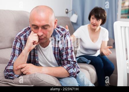 Sad family having difficulties in the living room at home Stock Photo