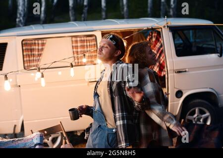 Young couple dancing together during camping in the forest Stock Photo