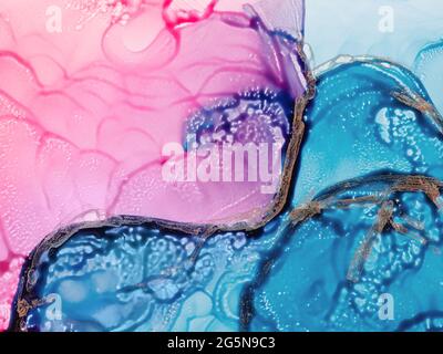 Alcohol ink fluid art. Waves in blue and pink colors with liquid golden inclusion. Abstract gradient background or texture Stock Photo