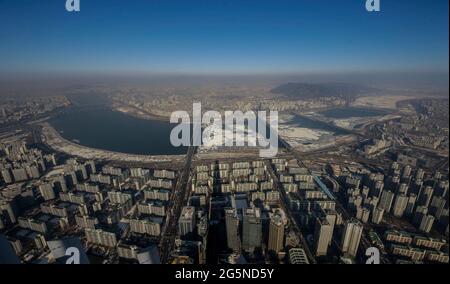 Daylight scene of Seoul, view from Lotte World Tower top. Lotte World Tower is a 123-floor, 554.5-metre (1,819 ft) supertall skyscraper that finished external construction on March 17, 2016. The building's final 123rd floor was topped out on December 22, 2015. It is currently the tallest building in the OECD, and is the 5th tallest building in the world. Stock Photo