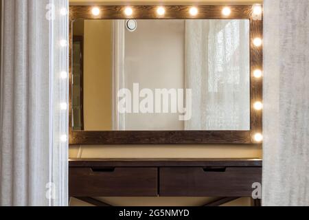 Woman's makeup place with mirror and empty shelf. Stock Photo