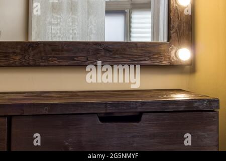 Woman's makeup place with mirror and empty shelf. Stock Photo