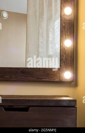 Woman's makeup place with mirror and empty shelf. Stock Photo