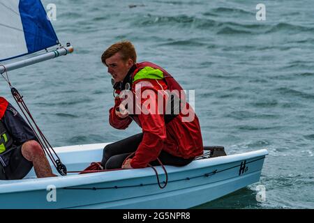 Sailing dinghy sails during sail club regatta near Greystones, Irish Sea. Stock Photo