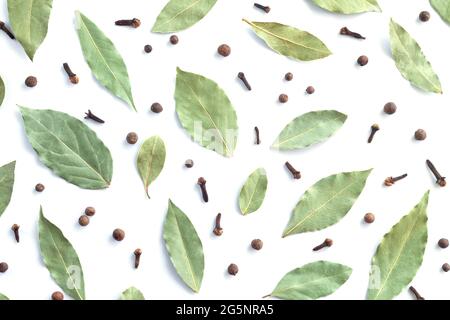 Dry bay leaves or laurel, black pepper and cloves top view. Flat lay of cooking spices Stock Photo
